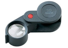 Load image into Gallery viewer, Small circular magnifying lens, encased in black plastic , fold-out case.