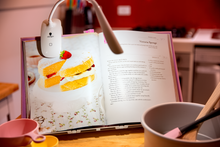 Load image into Gallery viewer, Smart Clip-on lamp being used for reading a recipe book