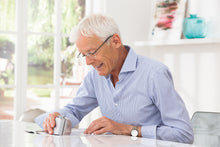 Load image into Gallery viewer, Man using segment magnifier to read