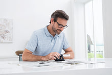 Load image into Gallery viewer, Man using Mobilux LED with mobase to read