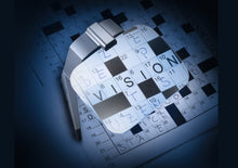 Load image into Gallery viewer, Scribolux, large rectangular lens suspended off of support base with LED light, displayed over crossword