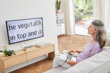 Load image into Gallery viewer, Woman using Smartlux DIGITAL as a screen reader, to read a book on a TV