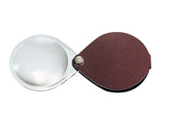 Load image into Gallery viewer, Circular magnifier inside clear oval setting, with attached fold-out burgundy