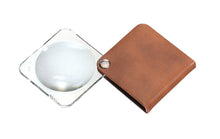 Load image into Gallery viewer, Circular magnifier inside clear square setting, with attached fold-out light browncase
