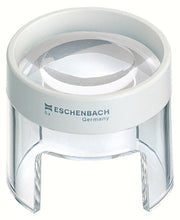 Load image into Gallery viewer, Small circular magnifier raised above work surface by clear stand, has an opening in base for working under magnifier