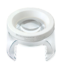 Load image into Gallery viewer, Small circular magnifier raised above work surface by clear stand, has an opening in base for working under magnifier
