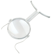 Load image into Gallery viewer, Clear plastic encasing large circular magnifying lens with a smaller, higher powered magnifying lens below. Clear feet designed to sit on chest and neck strap are shown.