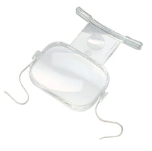 Load image into Gallery viewer, Clear plastic encasing large rectangular magnifying lens with a smaller, higher powered magnifying lens below. Clear feet designed to sit on chest and neck strap are shown.