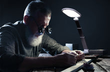 Load image into Gallery viewer, Man using Daylight's Foldi Go to examine a ring in a workshop.