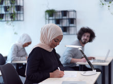 Load image into Gallery viewer, Woman using Daylight's Foldi Go in a class room.
