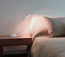 Load image into Gallery viewer, Daylight's Tricolour lamp on a bedside table.