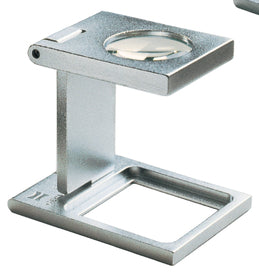 Small circular magnifying lens set in a rectangular metal casing, above a rectangular base.