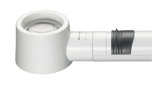 White, circular magnifier attached to battery handle