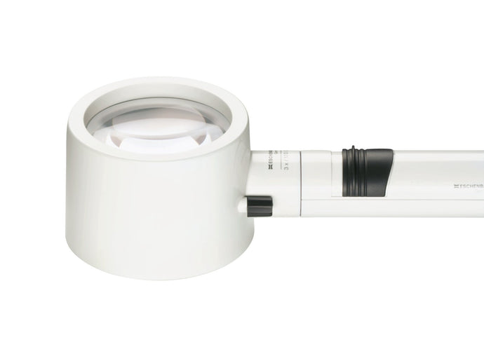 White, circular magnifier attached to battery handle 