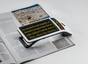 Eschenbach's Smartlux Digital magnifying text from a magazine with yellow on black text for increased.contrast