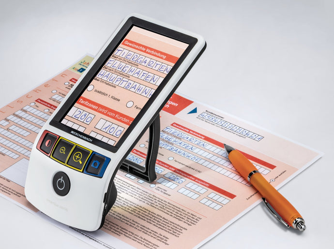 Eschenbach's newly improved Smartlux digital, magnifying a travel declaration document in German. 