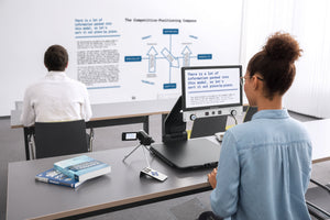 Woman using Vario DIGITAL 16 FHD advanced with an attached distance camera, to see a whiteboard in a classroom 