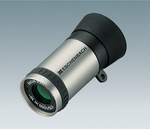 Silver cylindrical monocular with black eye-piece and Eschenbach logo printed onto silver housing, and black grip ring.