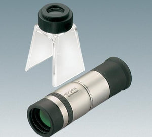 Handheld monocular with silver colour coating and black eyepiece, next to stand with eyepiece for converting monocular to stand magnifier or stand microscope