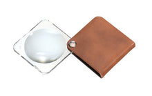 Load image into Gallery viewer, Circular magnifier inside clear square setting, with attached fold-out light browncase
