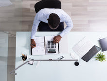 Load image into Gallery viewer, Overhead angle of a man working at an office desk with Slimline Table lamp
