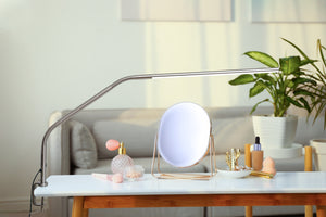 Slimline table lamp on a coffee table, being used for makeup application.