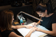 Load image into Gallery viewer, Daylight&#39;s Slimline Floor-standing lamp being used in a nail salon.
