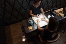 Load image into Gallery viewer, Daylight&#39;s Slimline Floor-standing lamp being used in a nail salon.
